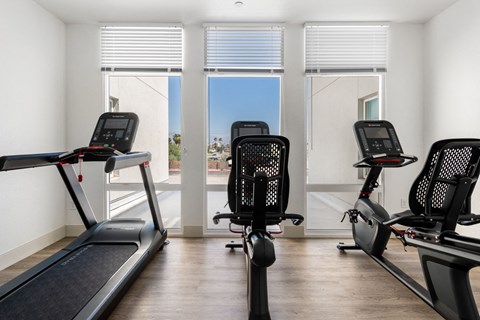 a gym with four treadmills and a treadmill